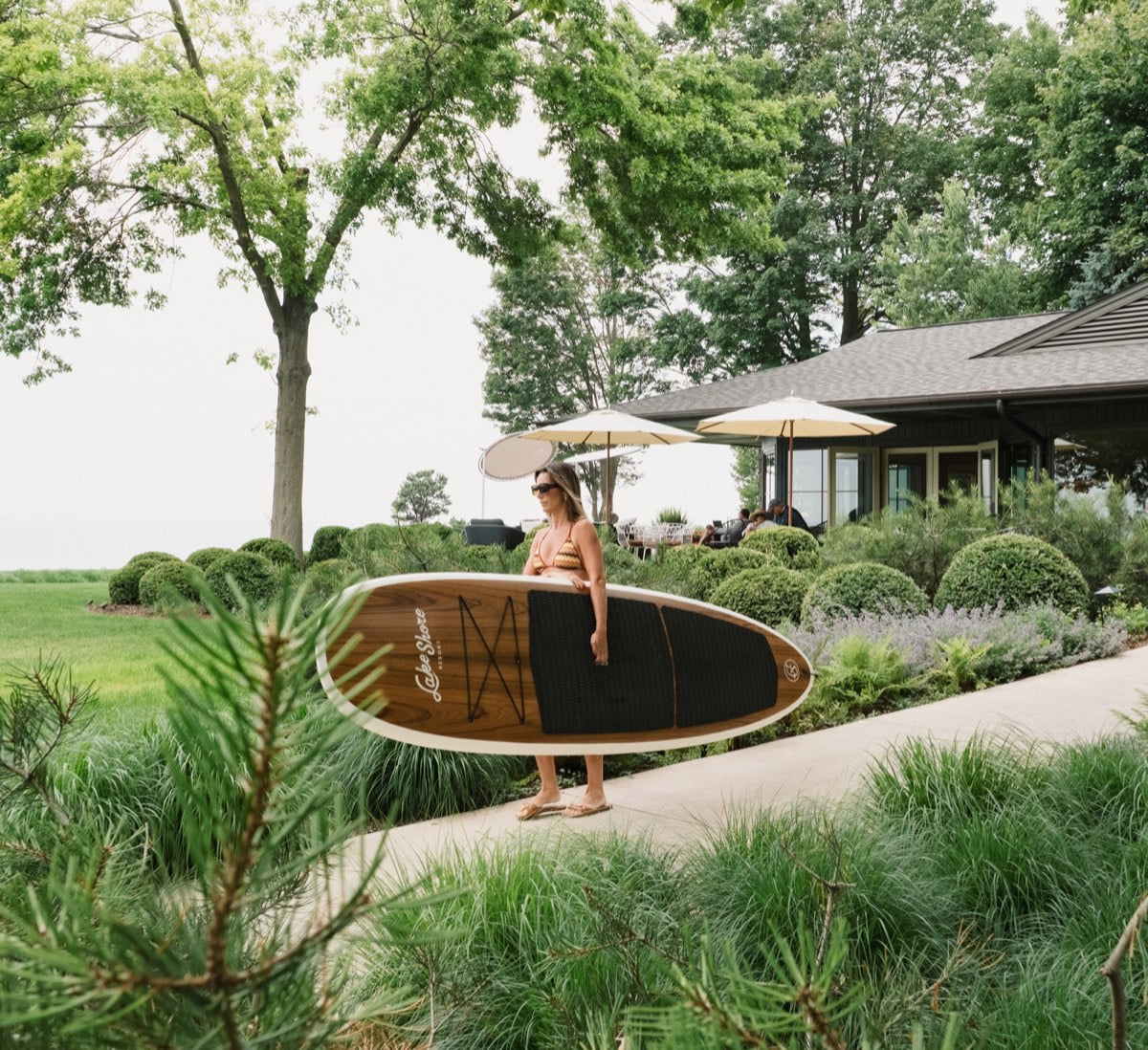 A Jarvis paddle board carried through the gardens at Lake Shore Resort